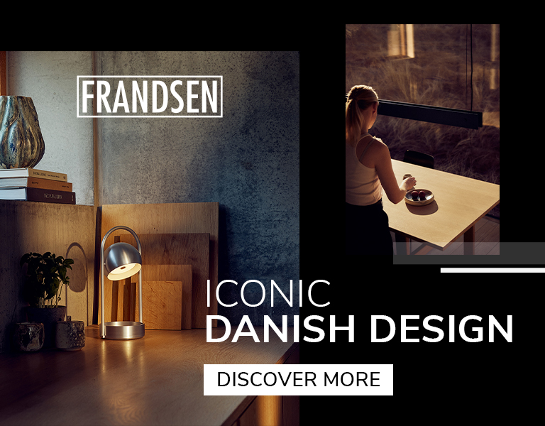 Discover More Frandsen Danish design lighting featuring a compact metallic table lamp on a wooden desk and a pendant lamp above a dining table with warm sunset lighting.
